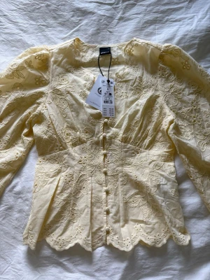 Gul blus med broderi från Gina Tricot - Helt ny ljusgul blus med prislapp kvar från Ginatricot i storlek S. Säljer för nypris 