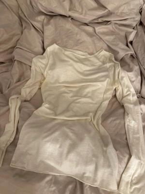 Ljusbeige långärmad topp från Intimissimi - Supermjuk och tunn långärmad topp från Intimissimi i ljusbeige färg. Toppen har en enkel och stilren design med rund halsringning och är tillverkad i ett lätt och stretchigt material som känns skönt mot huden.💗