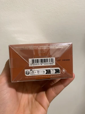 Parfums de Marly parfym Althair 125 ml - Lyxig parfym från Parfums de Marly ALTHAÏR i en elegant brun förpackning. Tillverkad i Frankrike och innehåller noter av linalool, citronellol och geraniol. Förpackningen har en stilren, rektangulär form och är tillverkad av kartong.