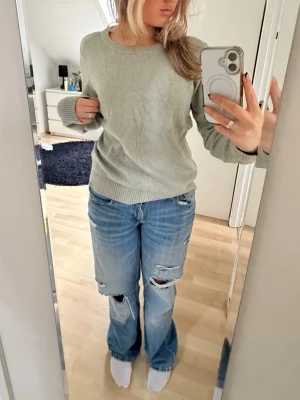 Ljus/mintgrön stickad tröja - En enkel och stilren mintgrön/ljusgrön stickad tröja med rund halsringning och ribbade muddar vid ärmslut och nederkant. Tröjan har en rak passform och är perfekt att ha på vintern men också som ”jacka” under sommaren. Materialet känns mjukt, tåligt och bekvämt. Har används ca 2 gånger men har inga defekter. Hör av er vid frågor🫶 