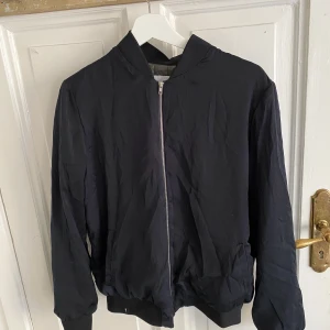 Svart Jacka från STAY - Svart tunn bomberjacka från STAY. Använd fåtal gånger.