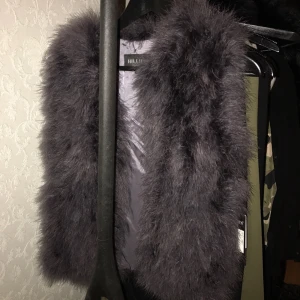 - Säljer en grå pälsväst i strutspäls, blandad färg mellan grå och lila. Från ett märke som heter Hollies. Nypriset står inte på etiketten men googlade runt och det ligger på runt 1498-1998:- Jag säljer den för 400:-   (Uppe på fler sidor) 