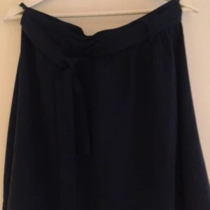  - Navy skirt , size 38 ( says 36 on the tag but it's more 38-40) , with a navy material stripe around. 100% lyocel. It is from the polish brand " Top Secret". I had in on maybe 2 times so it is in the perfect condition. Perfect for summer !