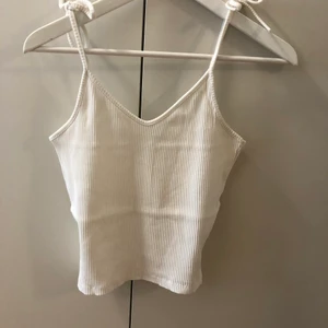 Linne med knytband - Vitt ribbat linne med knytband, storlek 36. Använt några gånger men i mycket bra skick! Längden på banden går alltså att justera då en knyter de själv. Skickas med skicka direkt, 50kr frakt.