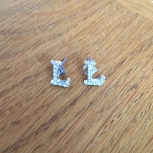 L-örhängen - Söta, silvriga örhängen som passar till allt! Aldrig använda. Köparen står för frakt (11kr), kan annars mötas upp i Stockholm!