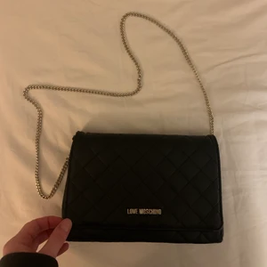 Moschino väska - Säljer nu min fina moschino väska. Väldigt bra begagnat skick! Ny pris 1100kr. Stilren och funkar till allt. Frakt kan tillkomma💕 Pris kan diskuteras vid snabb affär. 