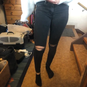 Håliga jeans - Svarta jeans med hål i. Jeansen är från Nelly och är nästan aldrig använda pga att jag inte gillar tajta jeans. Färgen är lite grå svarta. Säljer för 70kr frakten går på 63kr