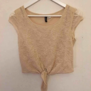  - Supersöt t-shirt i spets med transparenta ärmar och knytning. Ljusrosa, puderrosa, smutsrosa, mot beige. Mindre ”gul” än det dåliga fotot! Litet lätt magtröja.  Kan mötas i Stockholm eller skicka mot fraktkostnad! ✨🌸✨