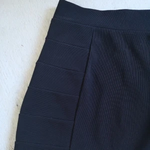  - Kort tight kjol i tjockare syntetmaterial 