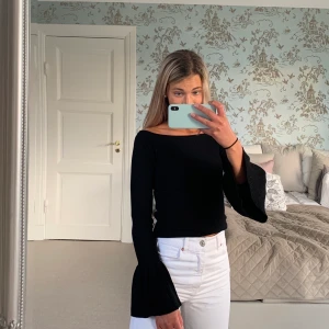 Tröja - Säljer denna snygga svarta ribbade tröjan med volanger i ärmarna från Gina Tricot. Stretchigt och väldigt skönt material! Pris: 100 kr. FRAKT TILLKOMMER💗🧚🏼