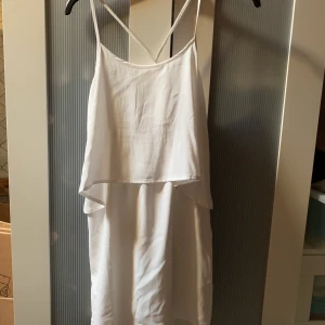 Vit klänning - Snygg vit klänning inköpt för studenten 2018 men aldrig använd. Storlek s, ”saxad” i ryggen, lite över knäna i längd. Eventuell frakt tillkommer 