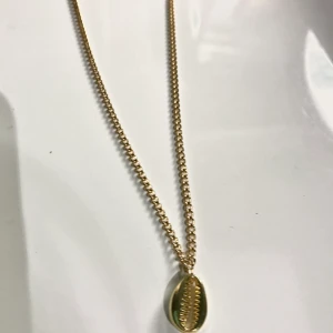 Guldfärgat snäckhalsband - Ett guldfärgat halsband med snäcka som är 40 cm långt. 40kr + frakt. Hör av dig via DM vid intresse eller frågor. Kram!