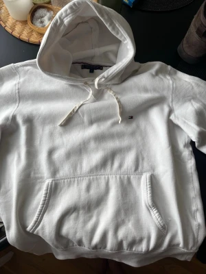Vit hoodie från Tommy Hilfiger - Säljer en jätte fin vit hoodie ifrån Tommy hilfiger i storlek M, bra skick! Inga fläckar. Killmodell.