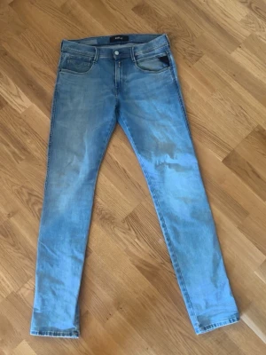 Ljusblå replay jeans - Snygga ljusblå slim fit jeans med klassisk femficksdesign och normal midja. Jeansen har en fräsch tvätt och raka ben, perfekta till en avslappnad stil. Materialet är mjukt denim som ger en skön känsla hela dagen.
