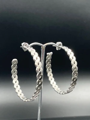 Nya Stora Flätade Hoops i Kirurgiskt Stål 4,5 cm från Svenska Lois Lane – Butikspris ca 399 kr - Trendiga hoops från svenska Lois Lane i kirurgiskt rostfritt stål. Helt nya och oanvända med stilren flätad design som passar både vardag och fest. Nickelfria och bekväma att bära. Diameter ca 4,5 cm. Butikspris cirka 399 kr – här får du ett kvalitetssmycke till ett betydligt bättre pris. Bundlerabatt erbjuds vid köp av flera av mina annonser. 