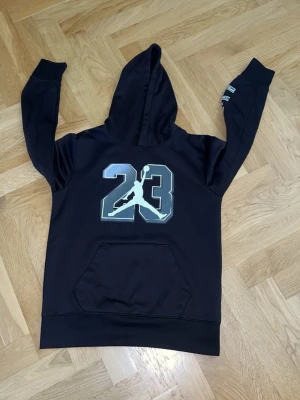 Air Jordan hoodie Strl 132/147 - En svart Jordan hoodie med Jordan loggan tydligt i mitten. Det står även Jordan AIR på armen