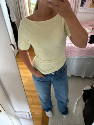 Ljusgul topp med kort ärm - Säljer en ljusgul topp med korta ärmar och rund hals. Använd en gång utan några tecken på användning.💞