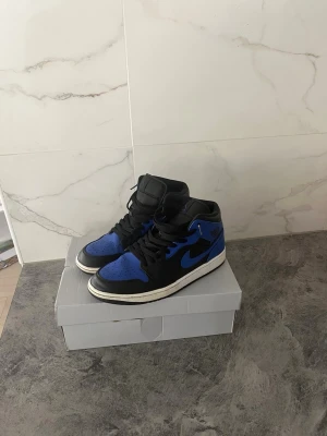 Jordan 1 - Säljer mina Jordan 1 i svart/blå färg. Skorna är i mycket bra skick och har använts få gånger. Storlek 44