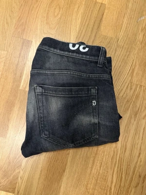 Dondup George 30 - Säljer ett par svarta Dondup George slim fit jeans med snygga tvättade detaljer. Jeansen har klassisk femficksmodell och normal midja. Perfekta för dig som vill ha ett modernt utseende. Nypris 3000 kronor. Hör av er vid frågor och funderingar!