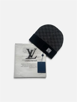 Svart stickad mössa med rutigt mönster – helt ny 🖤 - Tidlös mössa i svart med ett diskret rutigt mönster och svart vik. Tillverkad i mjuk och värmande kvalitet som passar perfekt under kalla dagar. Helt oanvänd med etikett kvar och levereras i originalförpackning. En elegant accessoar som passar till det mesta. Välkommen att kontakta oss vid frågor. 🧣✨