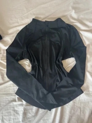 Svart slim träningsjacka med dragkedja - Snygg tränings jacka som tyvärr är lite för liten för mig. Köpte på Vinted så vet tyvärr inte märke. Hyfsat liten i modellen.