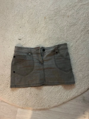 Grå jeanskjol med fickor - Grå jeanskjol, använd typ 2 gånger! Det står 14 EUR 42, men skulle säga att den passar xs-M.