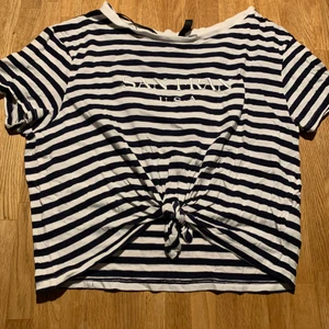 Black & white striped t-shirt - Black & white t-shirt with a knot and it’s a little short around the waist