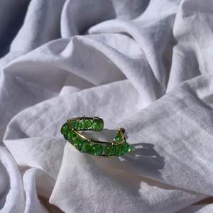 Handgjord ring med gröna pärlor, och guldpläterad koppartråd. Den är justerbar.