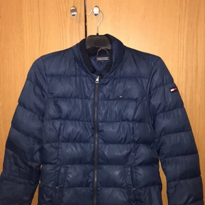 Tommy Hilfiger höst/vår jacka  - Hej, säljer en marinblå Tommy Hilfiger höst/vår jacka i storlek 164. Den har två framfickor som kan stängas med en knapp men den saknar luva. Nypris 1699kr  Mitt pris 350kr eller bud Finns att hämta i Kävlinge eller kan jag skicka den men köparen står för frakt  Fler bilder kan fixas vid önskemål 