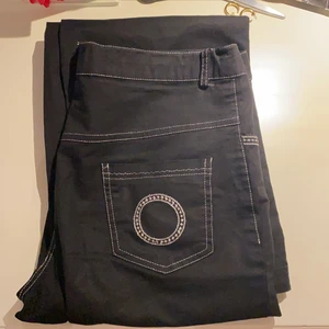 Svarta byxor - Svarta byxor med coola silver detaljer. Sitter mid/low-waist och är lite flare! Passar mig superbra som är 174cm lång.