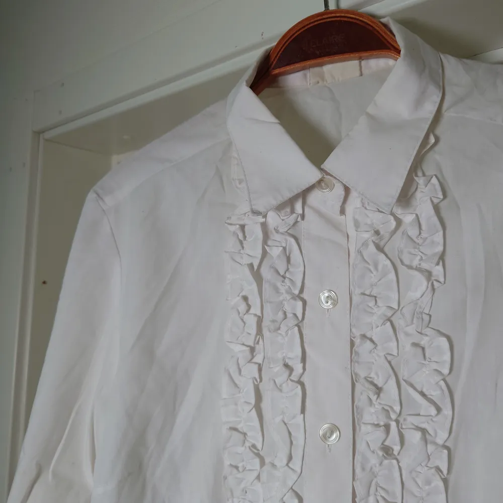 Klassisk vit skjorta med krås. Ingen storleksmärkning men är som en M🍀. Skjortor.