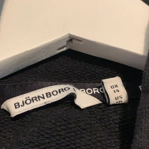 Björn borg svart hoodie  - Det här är en använd Björn Borg hoodie jag köpte för cirka ett halvt år sedan den är nu för liten för mig så därför säljer jag den. Plagget är kroppat och kan passa till valfria byxor, super snygga! (Strl 40) 