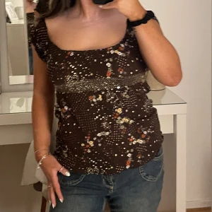 Gullig blommig topp - Skit gullig blommig topp i bra skick. Köpte vid barnavdelningen då jag ville att det skulle va lite tight. Materialet är väldigt strechig, så hade nog sagt att storleken är mellan XS-M