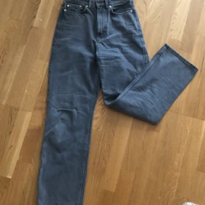 Jeans från Weekday - Rak passform i ljusgrå färg. Modellen är Rowe från weekday