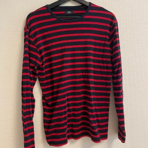 Randig tröja  - Randig tröja med svarta och röda ränder. Bär S och den är oversized på mig