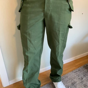 Försvarets modell 59 - Gamla byxor från försvarsmakten och har därför fantastisk kvalite. De har två benfickor, två byxfickor och en bakficka. Storleken är C48 som är ett internt mått men modellen är 180cm och 75 kg 