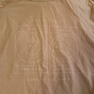 T-shirt, Gina tricot - Beige T-shirt från Gina tricot, mönstret är lite halvt borta men man ser fortfarande tydligt vad det är 