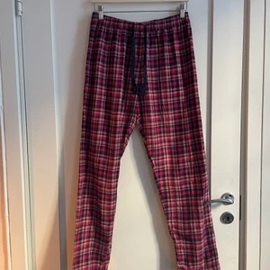 Pyjamasbyxor från Tommy Hilfiger - Rutiga pyjamasbyxor från Tommy Hilfiger i rosa och mörkblått. I storlek M. Knappt använda. 