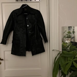 Skinnjacka🤍 - Svart skinnjacka med knappar och kortare ärm. Köpt secondhand för 800 kr. Använd en gång av mig. Står ingen storlek i men skulle gissa på Small. Kan mötas i Göteborg eller skicka, köparen står för frakt.