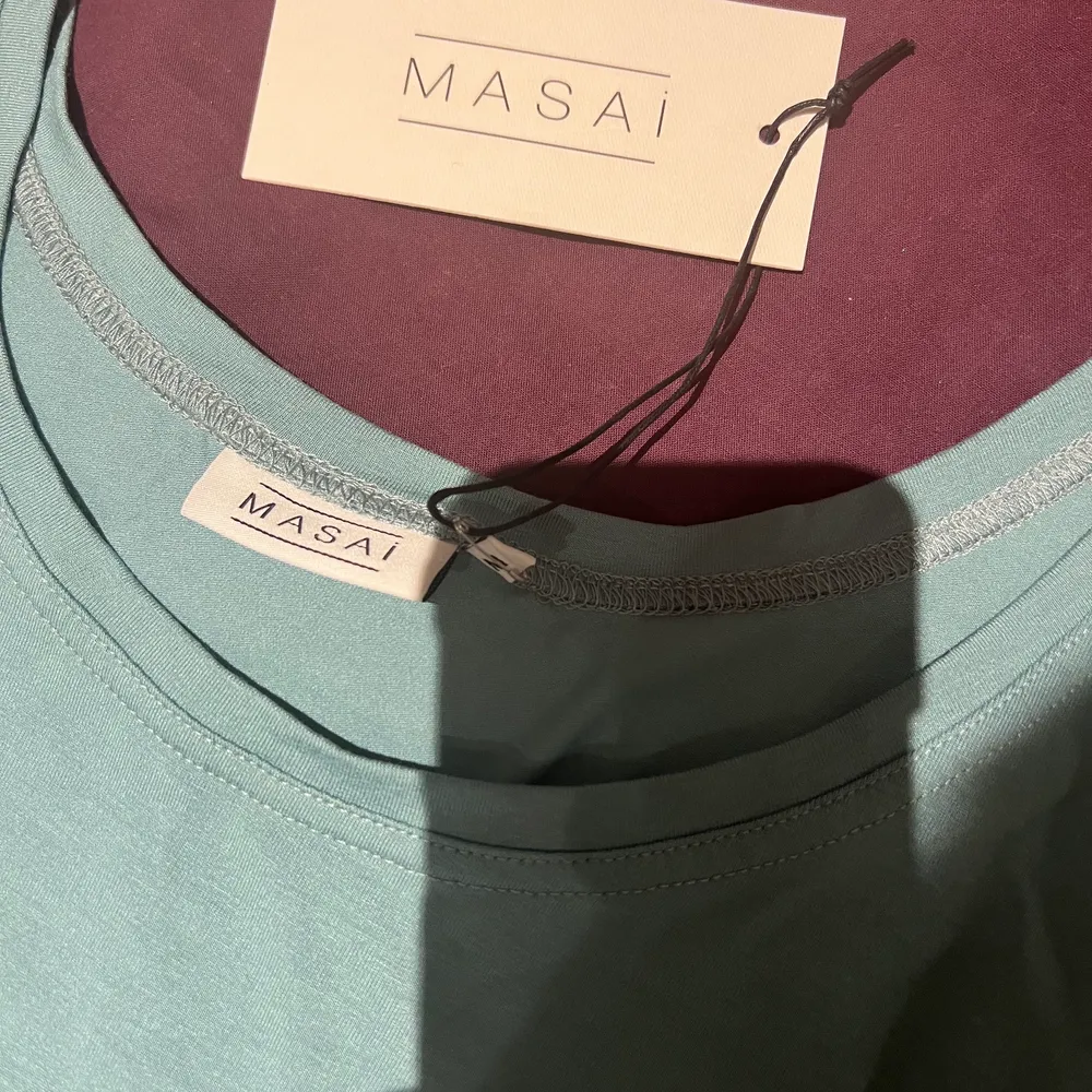 Basic, blå/grönt linne från masai, tjocka band, slapp modell. Kan kläs upp och kan kläs ner.  Ordinarie pris 319 kr, säljs för 100 kr.. Blusar.