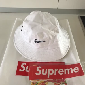 Supreme bucket hat - Vit Supreme hatt som aldirg har används. Storlek M/L. Hatten köpt 2019 om jag minns rätt, från Supremes hemsida. Stickers och påsen medföljer.