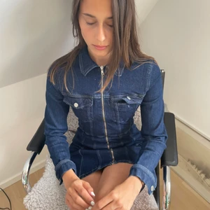 Jeansklänning - Jeansklänning från weekday i bra skick. Modellen är 1.77 och klänningen är en aning kort på henne. Man kan ha den både lite uppknäppt eller hela vägen upp. Inköpt för 399kr. Storlek S. Ena fickan är tyvärr trasig.