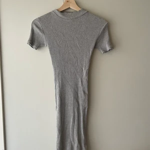Grå stickad klänning - Grå stickad klänning från Cubus i XS.