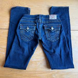 Ett par mörkblå True religion jeans med låg midja och lite bootcut. I använt men väldigt bra skick!   Storlek W24. Längd på innersömm 82cm.