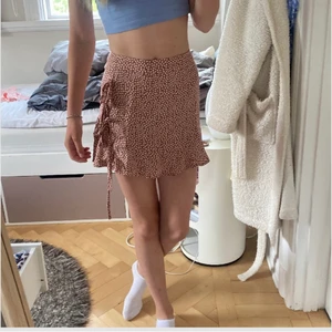 Söt omlott kjol - Söt omlottkjol i rött tyg med söta vita blommor på. PERFEKT till sommaren. 😻 Säljer eftersom den TYVÄRR har blivit för liten 😭