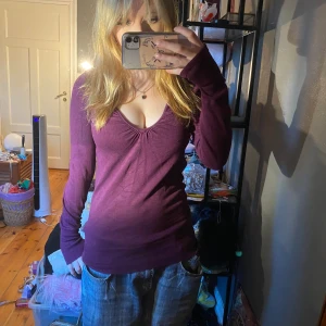 Vinröd tröja från Bershka - Säljer en snygg vinröd tröja från Bershka. Den är i storlek M och har en v-ringad design med långa ärmar och sitter med kroppen💖