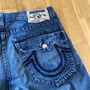 Ett par blå true religion jeans.  Storlek:W33 L34