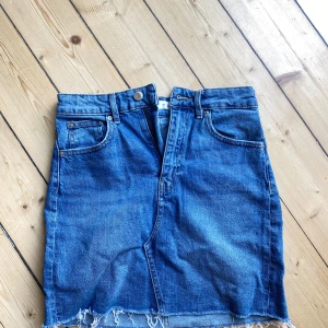 Blå jeanskjol från Perfect Jeans - Säljer en snygg blå jeanskjol från Perfect Jeans i storlek 34. Kjolen har en klassisk femficksdesign och en rå kant nertill som ger en cool och avslappnad look. Perfekt för både vardag och fest! 🥰
