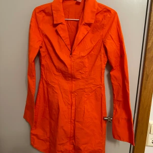 Klänning från H&M - En klänning från H&M i Skjortmaterial.  Armarna räcker hälften av händerna.