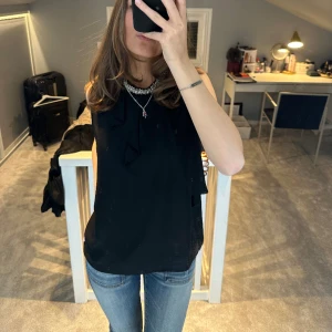 Svart topp - Säljer denna svarta topp med volang och glitter detalj ❤️